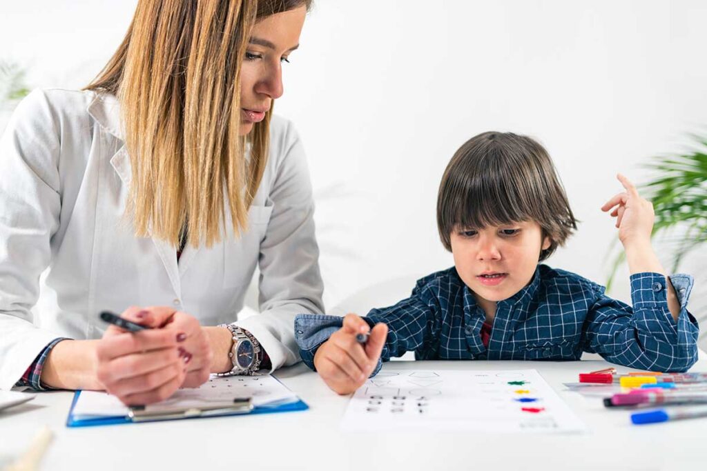 a mother sits with her young son and wonders about autism therapy programs in baltimore md